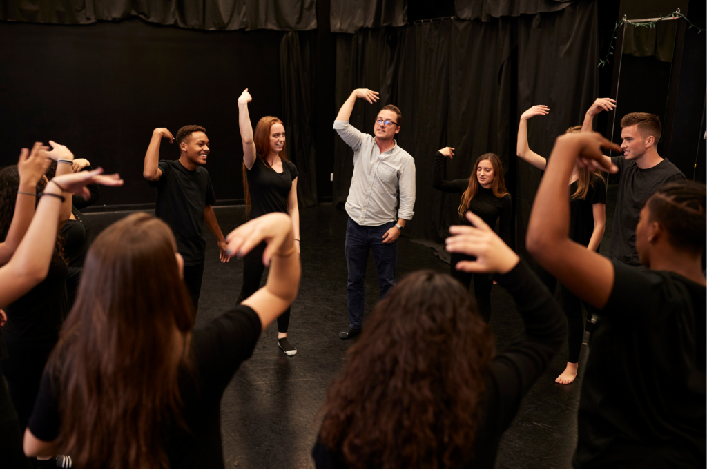 Students acting drilling with Broadway teacher
